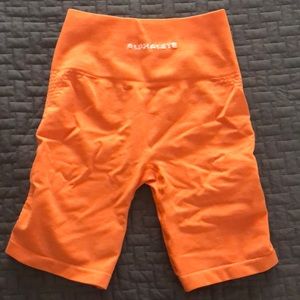 Alphalete orange biker shorts